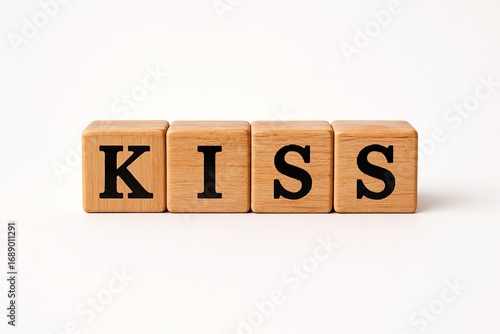 Wooden blocks spelling KISS on white background