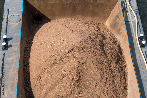 A boat carrying sand to be processed
