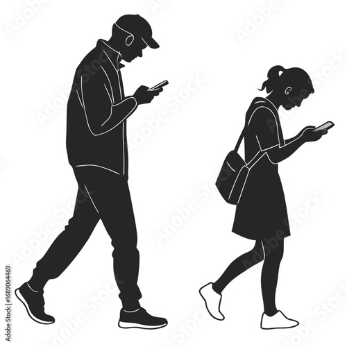 Silhouette of a man and a girl walking while looking at their mobile phones
