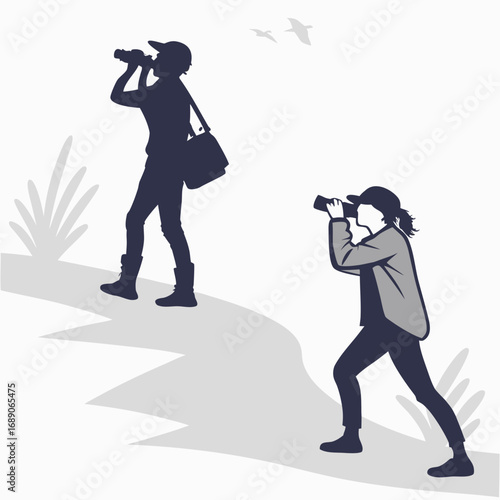 Two people birdwatching with binoculars on a grassy hill with birds flying overhead