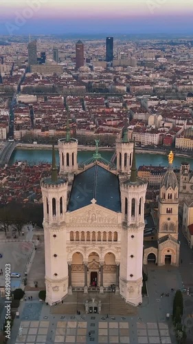 Vertical drone view of Fourviere Basilica facade plaza and modern skyline Lyon