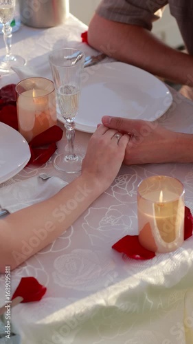 Romantic dinner with couple holding hands in vertical video
