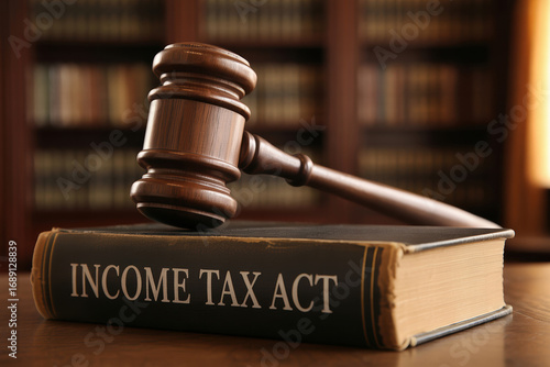 Income Tax Act A Gavel Resting on a Book Titled Income Tax Act in a Law Library Setting with Bookshelves in Background