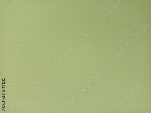 Green painted wall texture, smooth plastered surface background for design and decoration