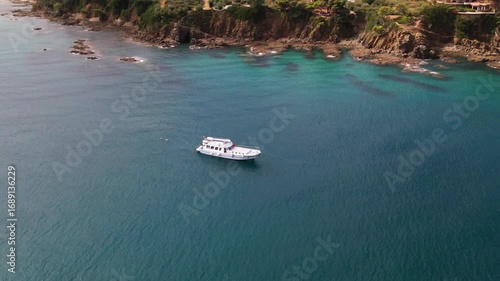Scenic Aerial Panorama with Drone Flying Around Small Boat by Coastal City Cefalù, Mediterranean Sea Sicily