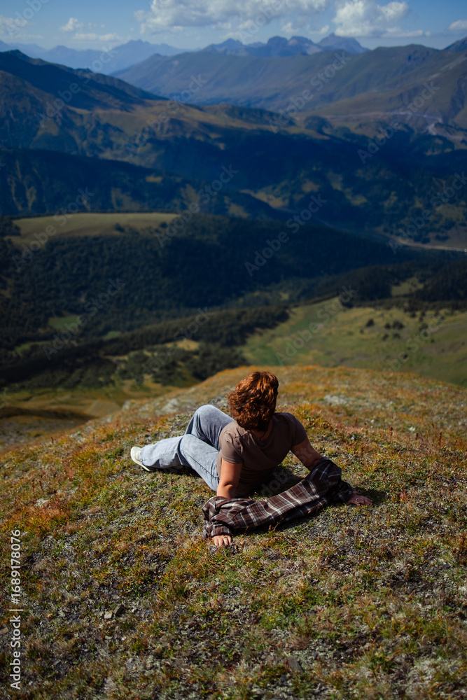 Fototapeta premium Happy woman enjoying freedom and fresh air on mountain top, relaxing in nature with scenic landscape view, travel and wellness lifestyle inspiration outdoors