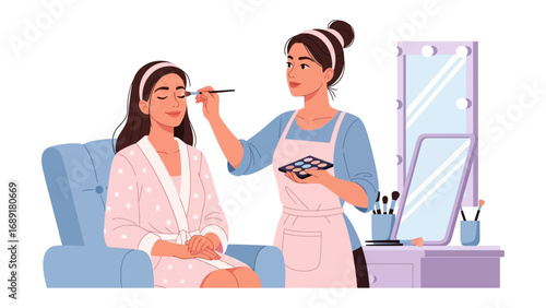 Professional makeup artist applying cosmetics to a woman sitting in a chair with a vanity and mirror