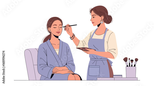 Professional makeup artist applying eyeshadow to a woman in a spa robe with a soft clean background