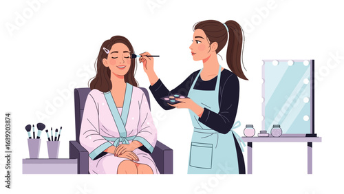 Professional makeup artist applying makeup to a smiling woman in a robe for a special occasion