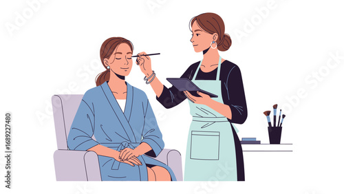 Professional makeup artist applying foundation to a client s face using a brush and tablet for reference