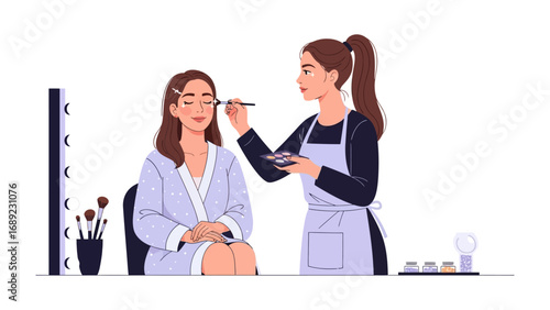 Professional makeup artist applying eye shadow to a seated client in a brightly lit studio