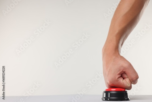 Obraz na płótnie Man pressing red button on white background, closeup. Space for text