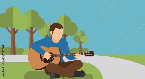 A young man finds a moment of peace and creativity, playing his acoustic guitar while sitting in a tranquil city park