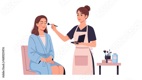 Professional makeup artist applying foundation to a client seated in a chair wearing a robe for a beauty treatment
