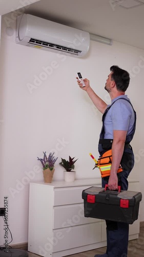 Technician installing and testing air conditioning unit