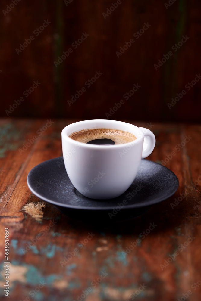 Obraz premium Cup of coffee on rustic wooden background. Soft focus. Copy space 
