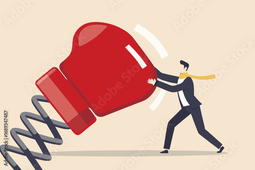 Businessman pushing a giant boxing glove on a spring symbolizing effort and impact