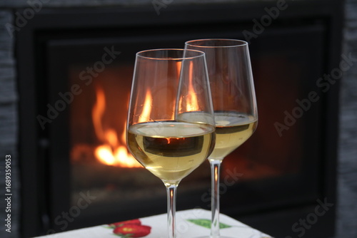 Glasses of white wine by the fireplace