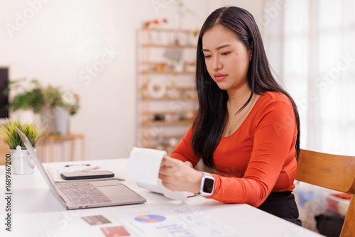 Photography asian woman working with calculator to calculate numbers