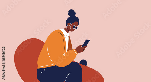 Stylish woman focused on her smartphone while relaxing on a sofa. Represents modern communication, digital lifestyle, online activities, or remote work.
