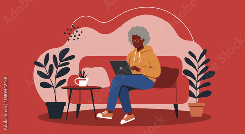 Senior Black woman comfortably uses a laptop on a sofa at home, embodying modern digital engagement and remote connectivity for mature adults.