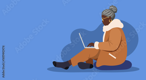 Mature Black woman focused on her laptop, depicting modern technology use, digital learning, and engaged senior lifestyle.