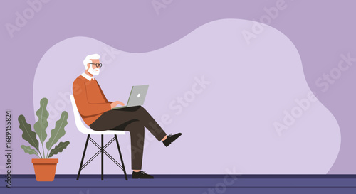 Modern senior man with a beard and glasses uses a laptop, representing digital literacy, remote work, or an engaged active lifestyle.