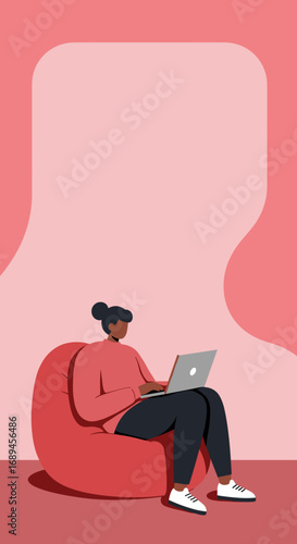 Woman working comfortably on a laptop from a bean bag chair at home. Ideal for concepts of remote work, freelancing, online learning, or a relaxed modern lifestyle.