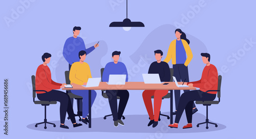 Diverse business team collaborating in a modern office meeting, utilizing laptops for projects and discussions, symbolizing teamwork and strategic planning.
