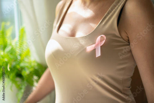 Wallpaper Mural Extreme close-up of pink satin awareness ribbon on clothing, representing compassion and solidarity during breast cancer awareness month. Torontodigital.ca