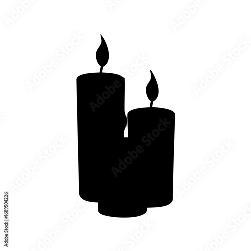 Two tall wax candles in black silhouette, bright light illuminating the scene