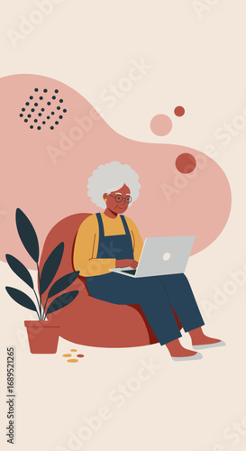 A modern senior woman comfortably uses a laptop at home, embodying digital literacy, connectivity, and an active lifestyle.