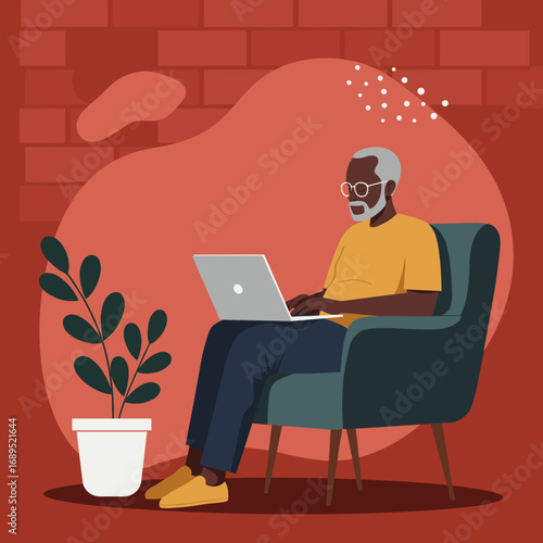 Senior Black man comfortably working on his laptop at home. Modern digital lifestyle, remote work, and technology integration for older adults.