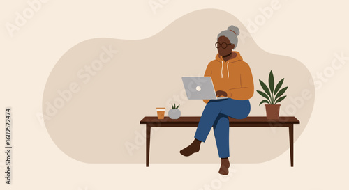 Stylish senior woman working on a laptop from home. Reflects remote work, online learning, and independent lifestyle for older generations.