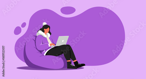 Young woman comfortably works on laptop from a beanbag chair, embodying remote work, study, or relaxed digital lifestyle. Cozy home office concept.