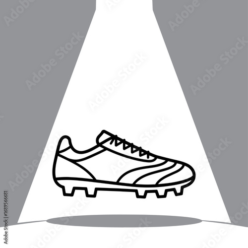 Spotlit Football Boot a Symbol of Athletic Prowess and Sporting Goods Excellence in Dynamic Black and White