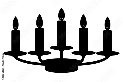 Silhouette of a candelabra with five lit candles