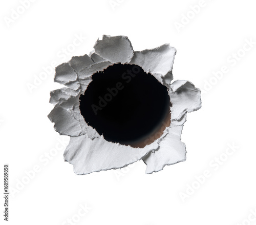 Close-up bullet hole in white material