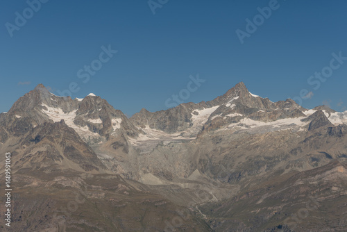Wallpaper Mural Mountain peak with snow cap and clear blue sky over rugged terrain during daytime Torontodigital.ca