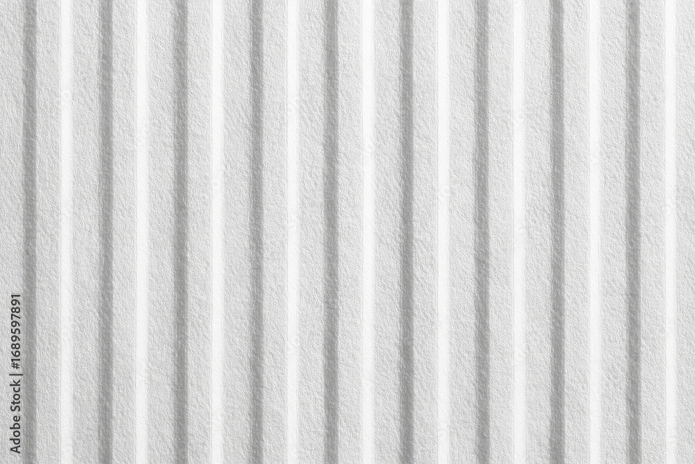 Obraz premium Close-up of a textured, white corrugated surface. Vertical, parallel ridges create a subtle, repeating pattern