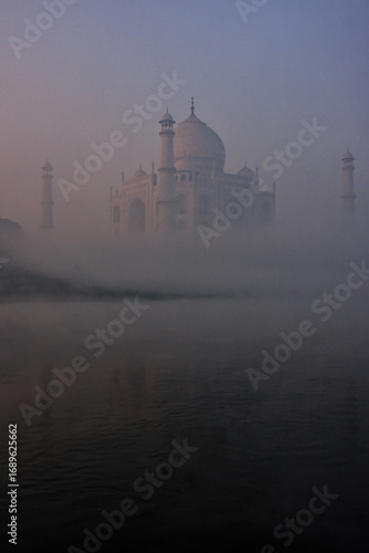 View of Taj Mahal reflected in Yamuna river with early morning fog, Agra, Uttar Pradesh, India