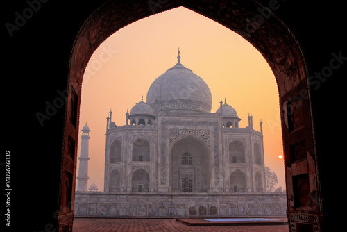 Taj Mahal at sunrise framed with the arch of the mosque, Agra, Uttar Pradesh, India