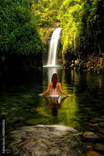 Young woman in bikini standing at Wainibau Waterfall on Taveuni Island, Fiji