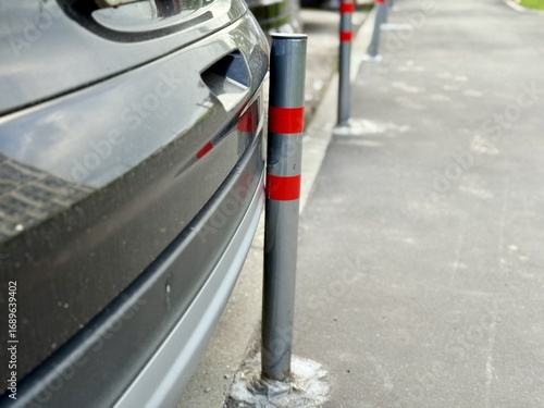 A car bumper accident involving a pole situated on the sidewalk has occurred recently. Cars bumper has sustained damage due to a pole positioned on the sidewalk, highlighting urban parking challenges