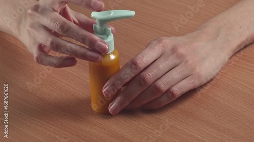Close-up of woman looking at shampoo in a small compact package at home, recorded with ambient sound.