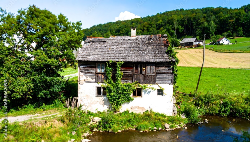 Fototapeta premium Old wooden house by a river