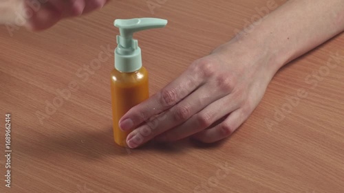 Close-up of woman looking at shampoo in a small compact package at home, recorded with ambient sound.