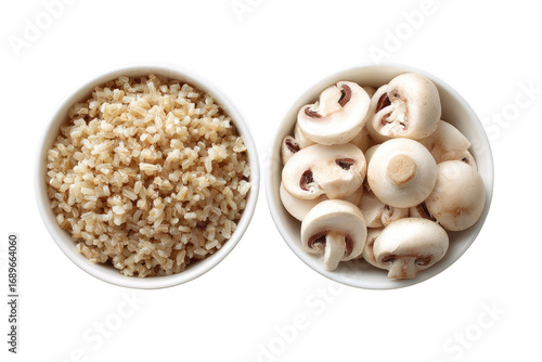 Two small white bowls, one with cooked brown rice, the other with sliced mushrooms, top view
