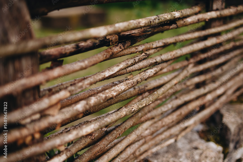 Fototapeta premium Rustic Woven Wooden Fence Close-up View
