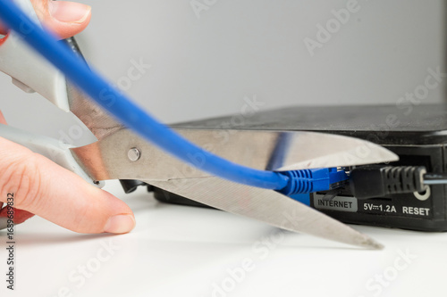 Scissors cut the router cables. 